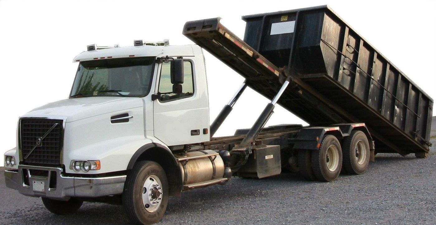 Roll-off truck hoisting a roll-off container